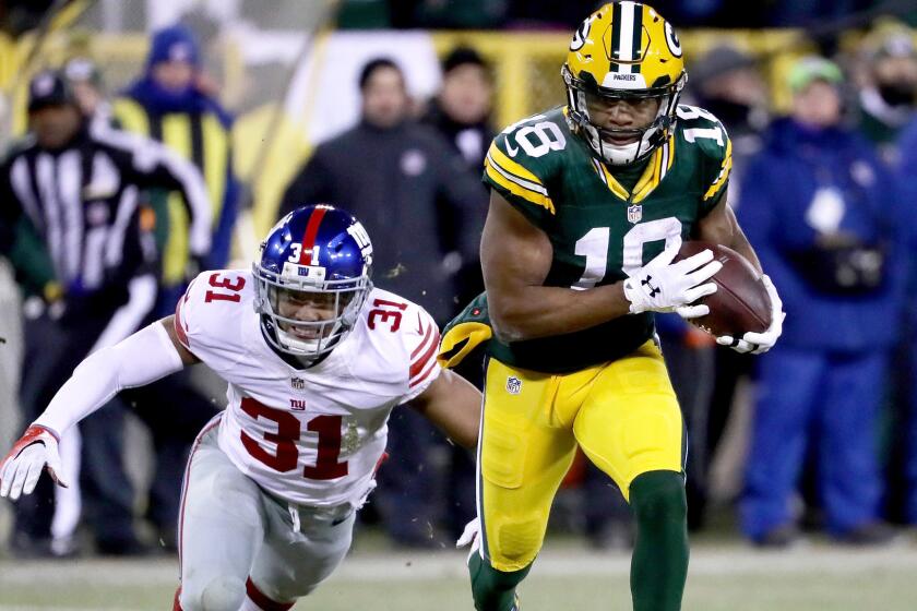 Packers receiver Randall Cobb, breaking away from Giants defensive back Trevin Wade in the third quarter, had three touchdown catches Sunday.