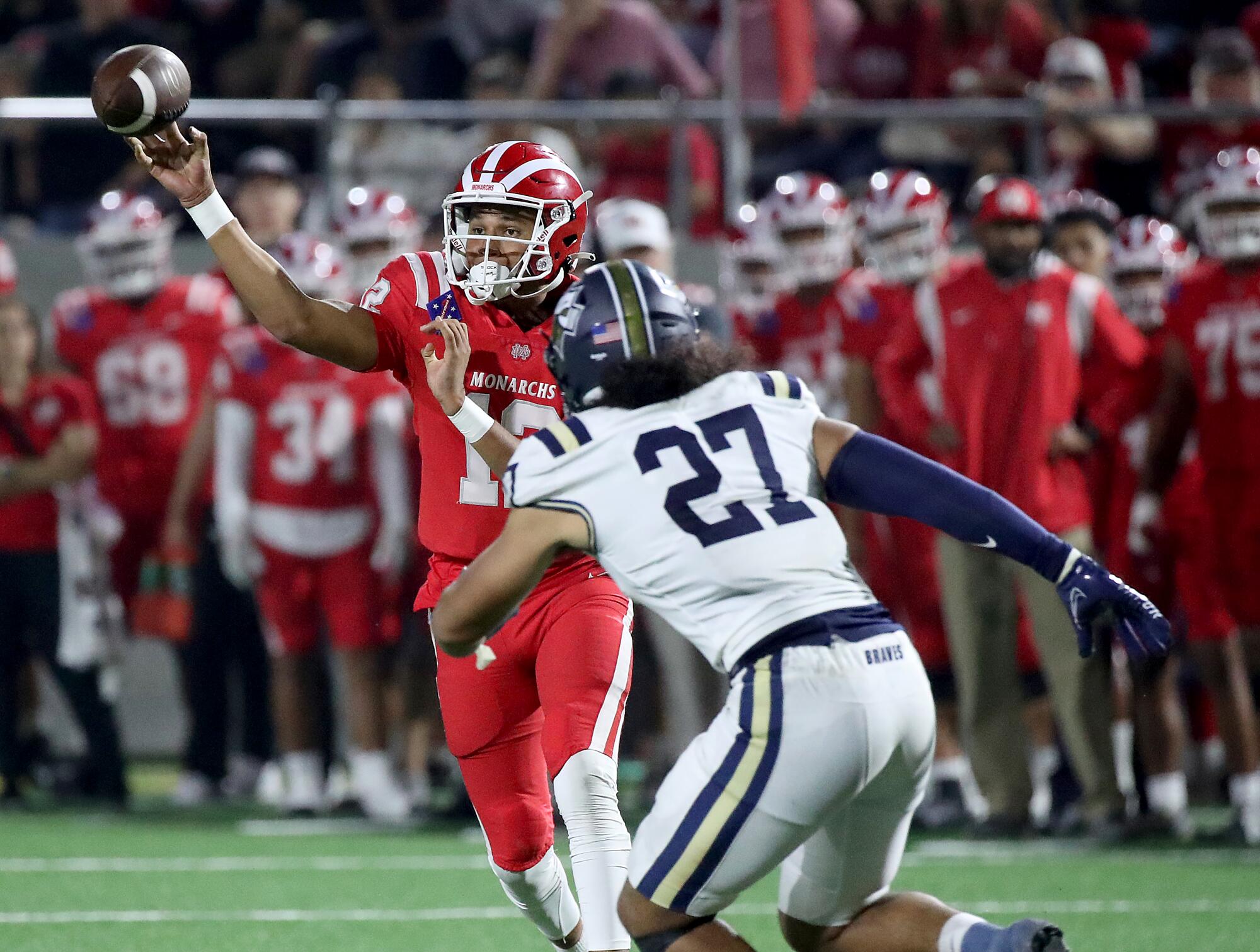 Mater Dei's quarterback throws a pass in front of a St. John Bosco player 