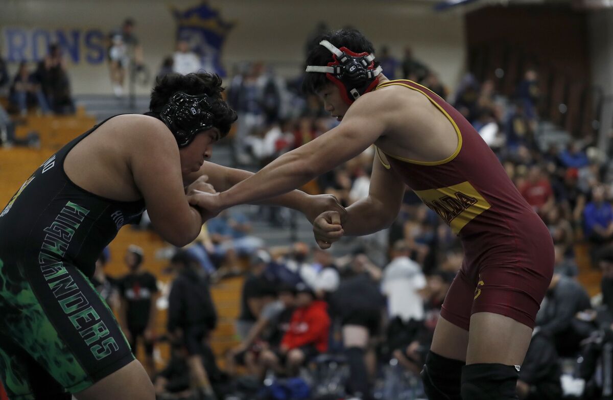 La Canada High's Kenneth Kim, right, competes against Upland in a heavy weight match.