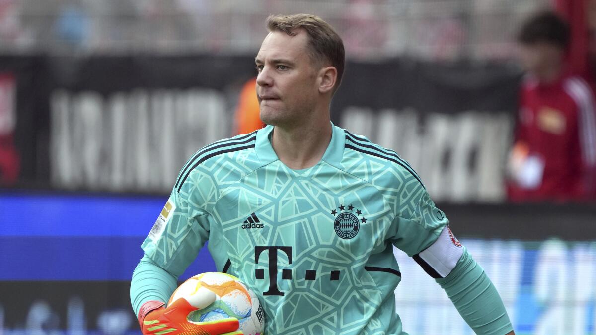 FILE -- Bayern's goalkeeper Manuel Neuer holds the ball during the German Bundesliga soccer match between 1. FC Union Berlin and FC Bayern Munich in Berlin, Germany, Saturday, Sept. 3, 2022. Bayern Munich and Germany goalkeeper Manuel Neuer says he was previously treated for skin cancer and had to undergo surgery. Neuer says he has a scar near his nose and that he was “operated on three times.” (AP Photo/Michael Sohn, file)