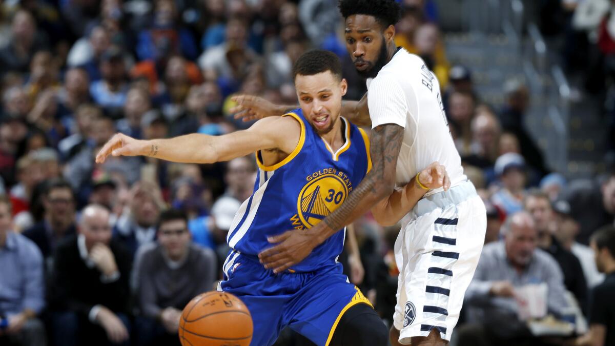 Warriors guard Stephen Curry, left, fights for control of a loose ball with Nuggets forward Will Barton during the second half Wednesday night.