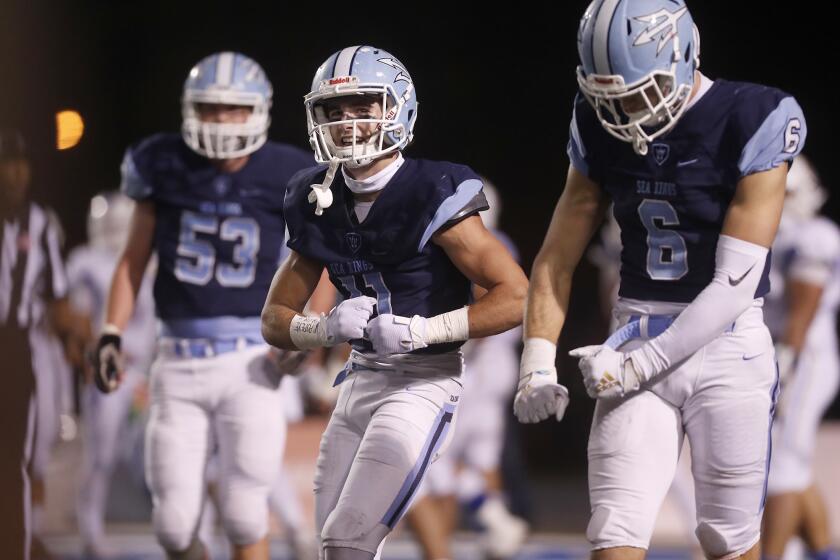 Corona del Mar's Bradley Schlom, center, and John Humphreys, right, do a celebratory handshake and dance after Schlom scored against Serra during the second half in the CIF State a Division 1-A title game at Cerritos College on Saturday.