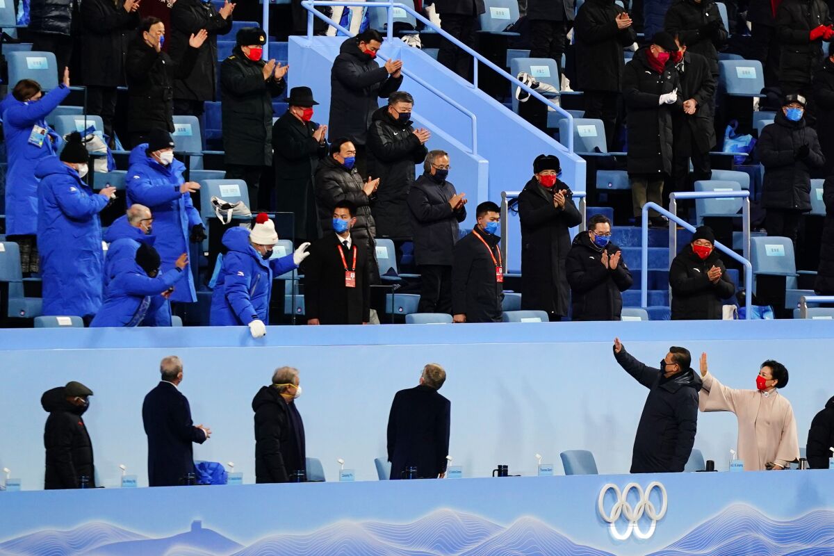 Chinese President Xi Jinping, bottom second from right, waves as he arrives for the opening ceremony of the 2022 Winter Olympics, Friday, Feb. 4, 2022, in Beijing. (AP Photo/Matt Slocum)