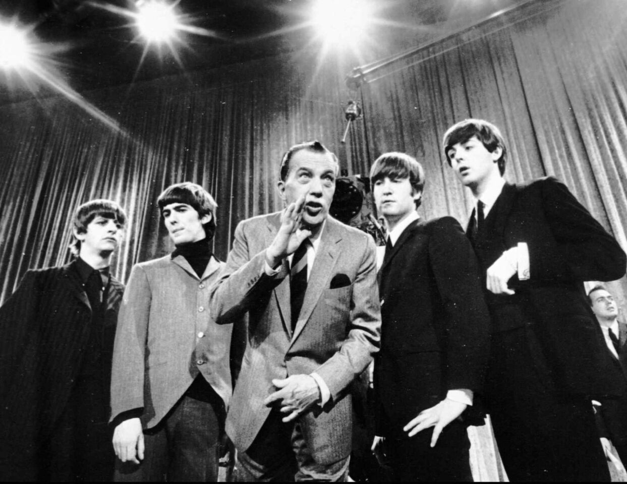 Longtime CBS mainstay Ed Sullivan rehearses his Sunday night television variety show with the Beatles in their first appearance in the United States, Feb. 9, 1964.
