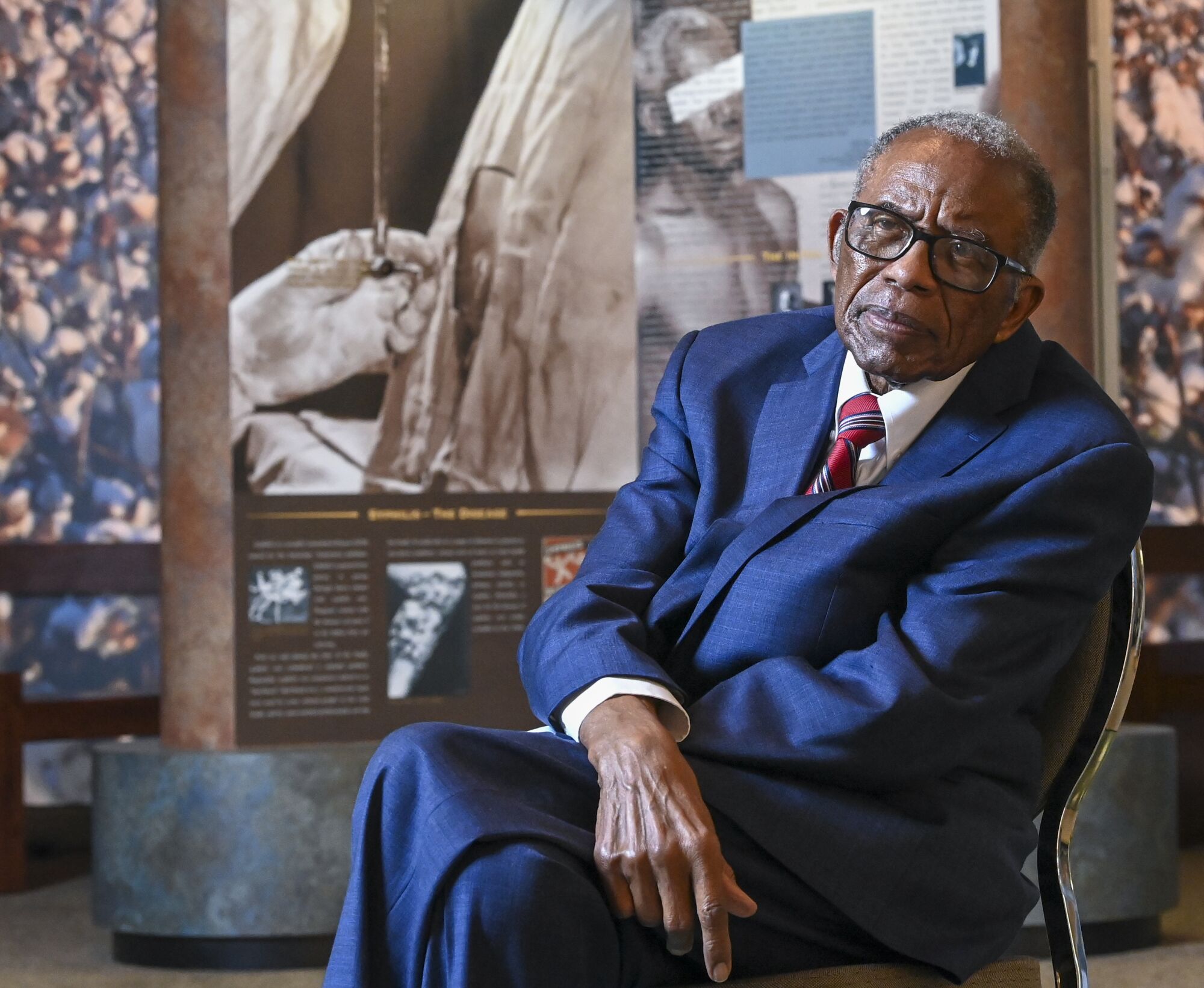 Civil rights attorney Fred Gray seated at a museum.