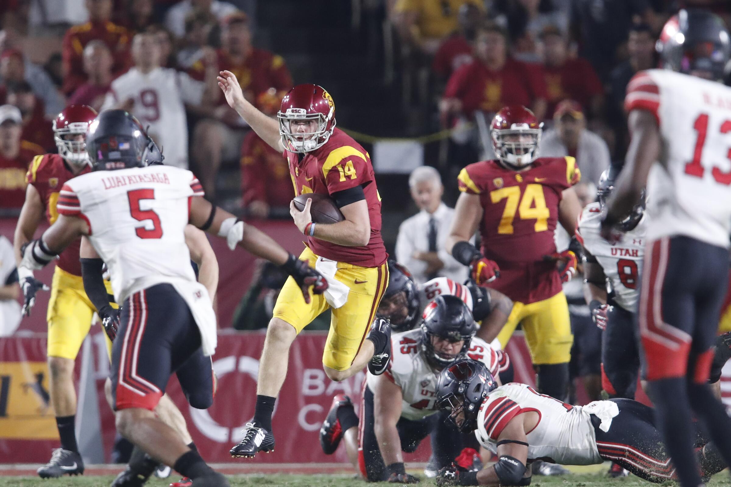 USC quarterback Sam Darnold leaps while running with the ball against Utah at the Coliseum.