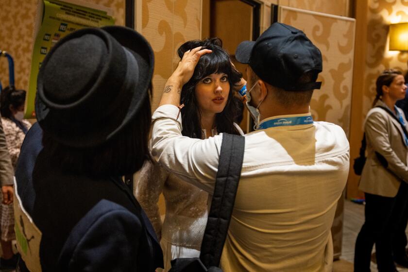 San Diego, CA - July 22: Austratlian actress Markella Kavenagh, who plays Elanor 'Nori' Brandyfoot, get's touched-up before the cast of Amazon Prime's, "The Lord of the Rings: The Rings of Power," visits media outlets at the Hilton San Diego Bayfront Hotel following their presentation in "Hall H," of the convention center, at San Diego Comic-Con, in San Diego, CA, Friday, July 22, 2022. (Jay L. Clendenin / Los Angeles Times)