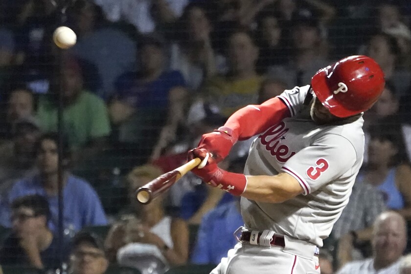 Philadelphia Phillies' Bryce Harper launches a three-run home run off Chicago Cubs relief pitcher Dan Winkler during the seventh inning of a baseball game Tuesday, July 6, 2021, in Chicago. Jean Segura and Brad Miller also scored on the play. (AP Photo/Charles Rex Arbogast)