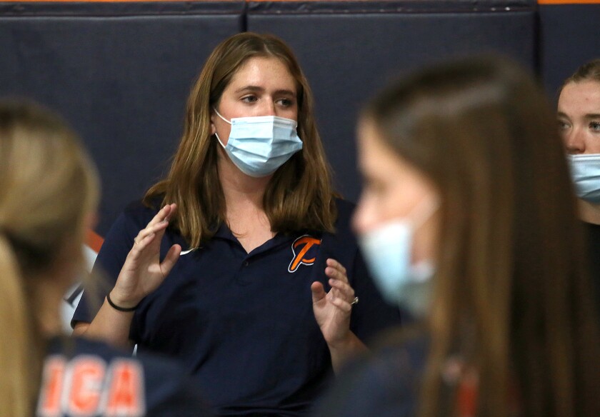Pacifica Christian High School varsity volleyball head coach Ally Forsberg talks with her players before Thursday's match.