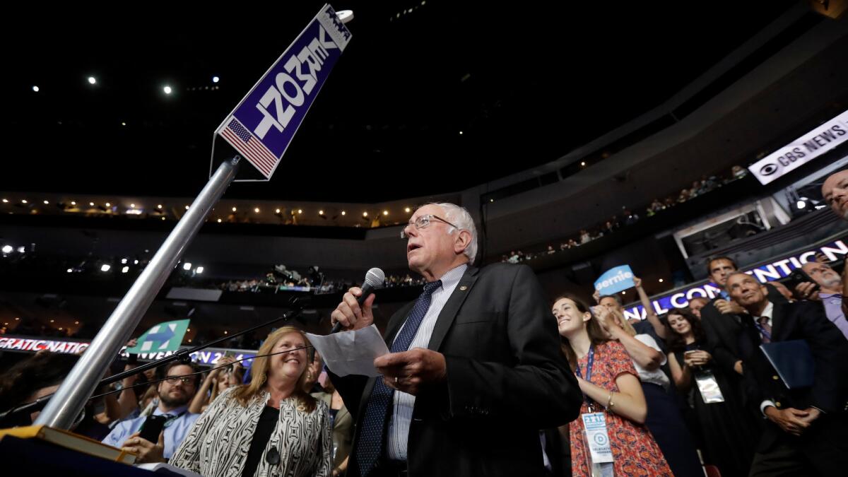 Former Democratic presidential candidate Sen. Bernie Sanders, I-Vt., stands with the Vermont delegation and asks that Hillary Clinton become the unanimous choice for President of the United States during the second day of the Democratic National Convention in Philadelphia.