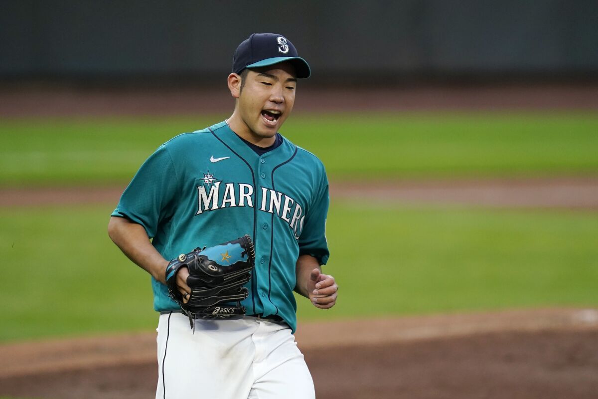 Seattle Mariners starting pitcher Yusei Kikuchi yells as Texas Rangers' Eli White grounds out in the third inning of a baseball game Friday, Sept. 4, 2020, in Seattle. (AP Photo/Elaine Thompson)