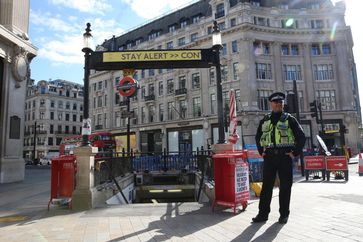 A police officer on duty at the Oxford Circus Tube station entrance in London on May 14, 2020. Britain has eased coronavirus lockdown restrictions.
