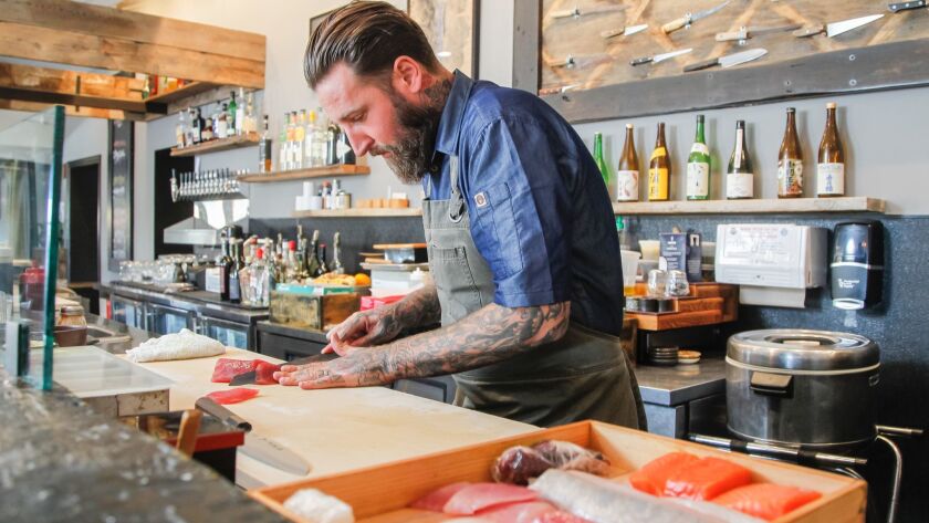 Chef/owner Rob Ruiz filets fish at his The Land & Water Company restaurant in Carlsbad Village in this October 2018 photo. 