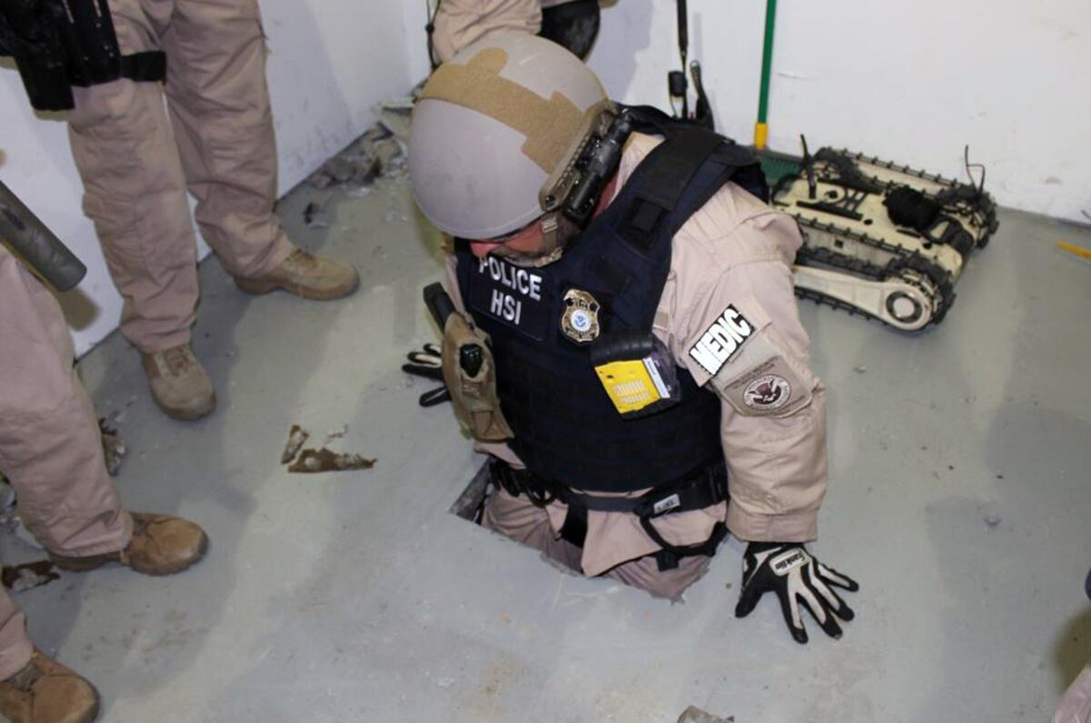 This image provided by the U.S. Immigration and Customs Enforcement (ICE) agency shows an agent examining one of two tunnels discovered April 1, 2014 in San Diego's Otay Mesa industrial park.