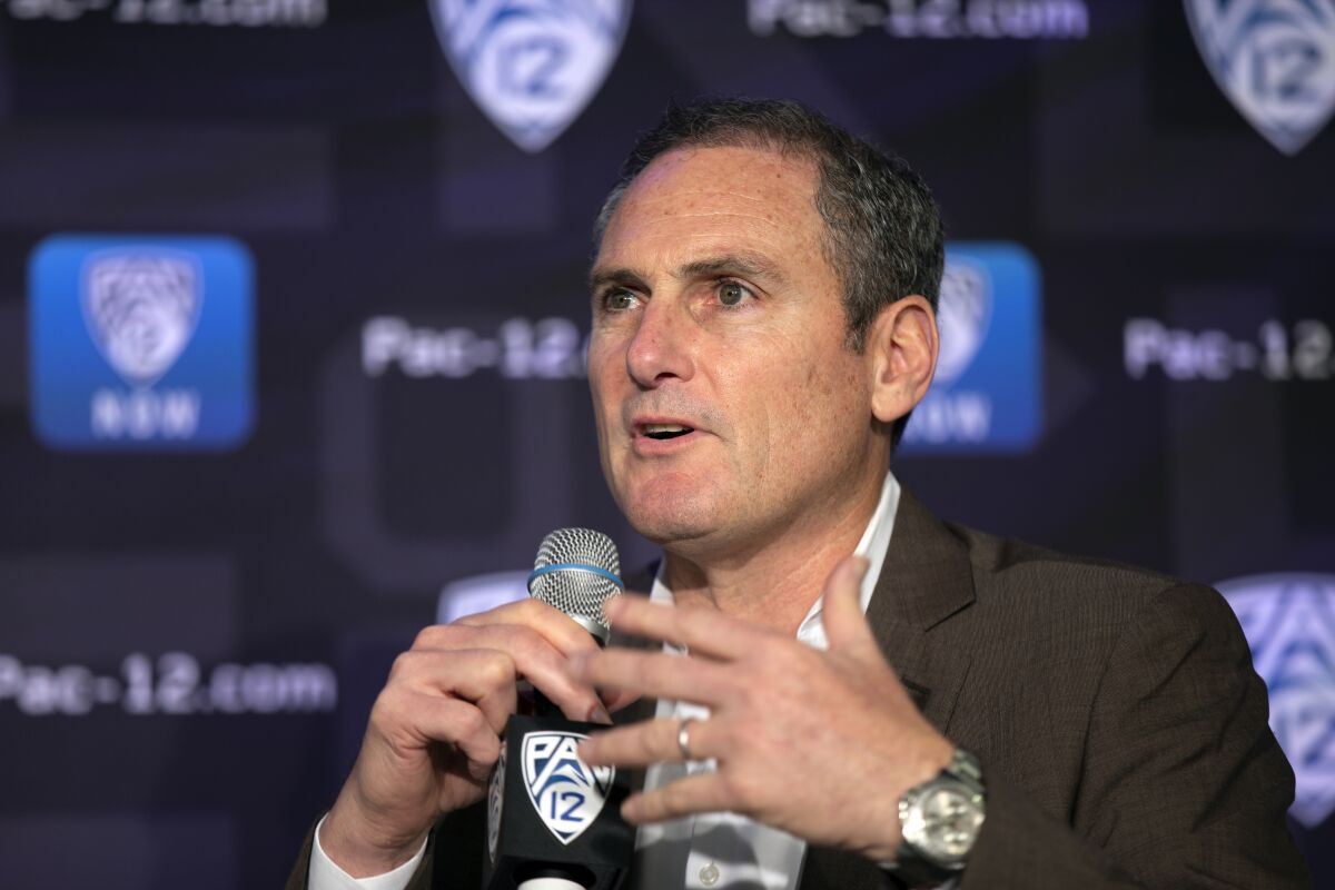 Pac-12 commissioner Larry Scott speaks to reporters during a news conference in 2019.