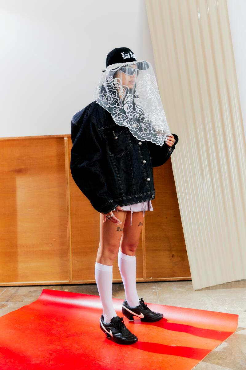 Ann-Marie Hoang stands on a red sheet of paper, wearing a veil.