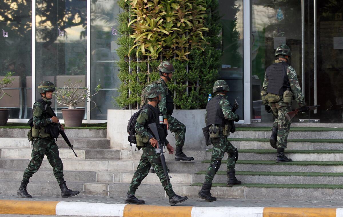 Soldiers enter the National Broadcasting Services of Thailand building in Bangkok, the capital. The army declared martial law in a surprise announcement.