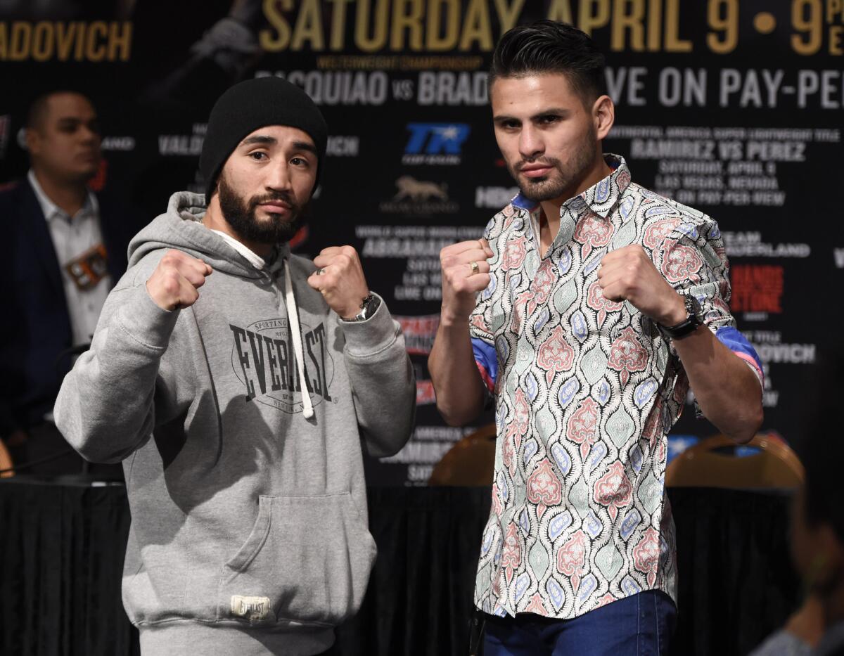 Manny Perez, left, and Jose Ramirez pose for photographers at a news conference this week in advance of their fight Saturday at MGM Grand Arena in Las Vegas.