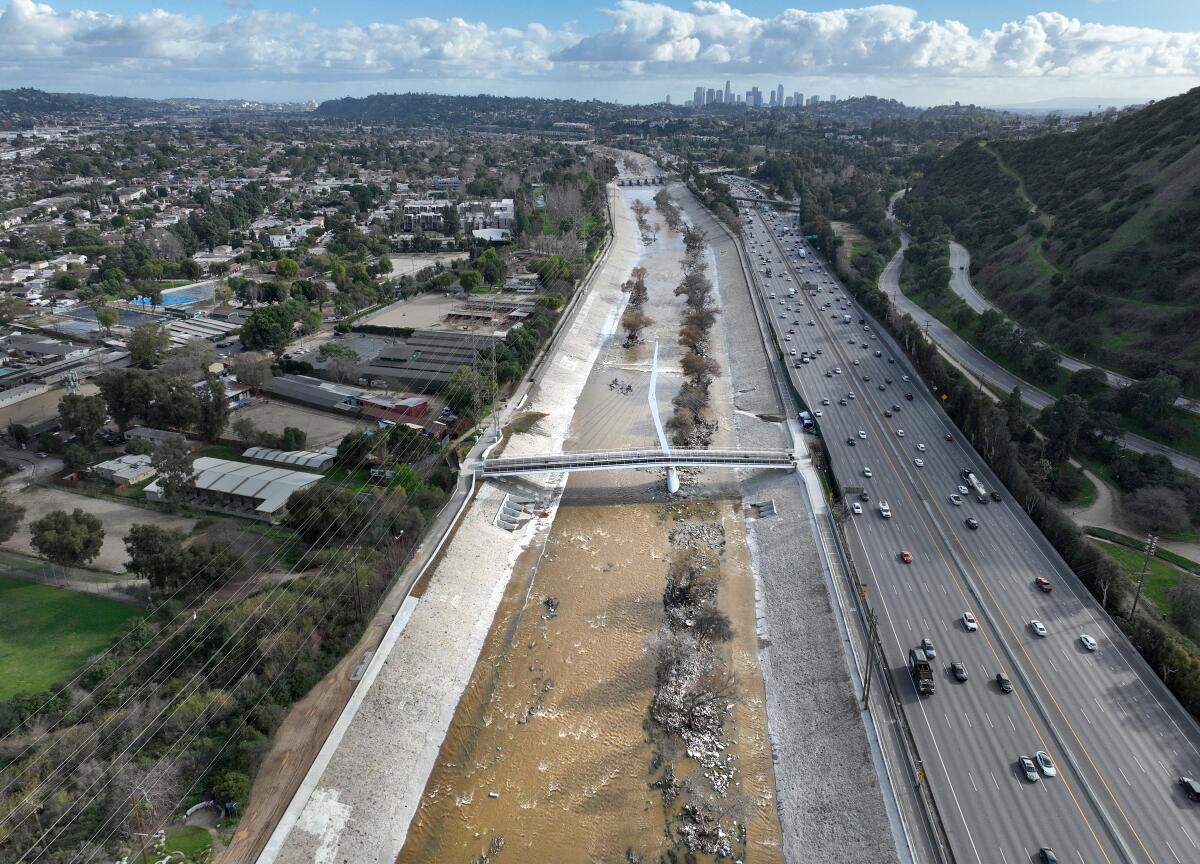 An aerial view of a freeway and a water channel.