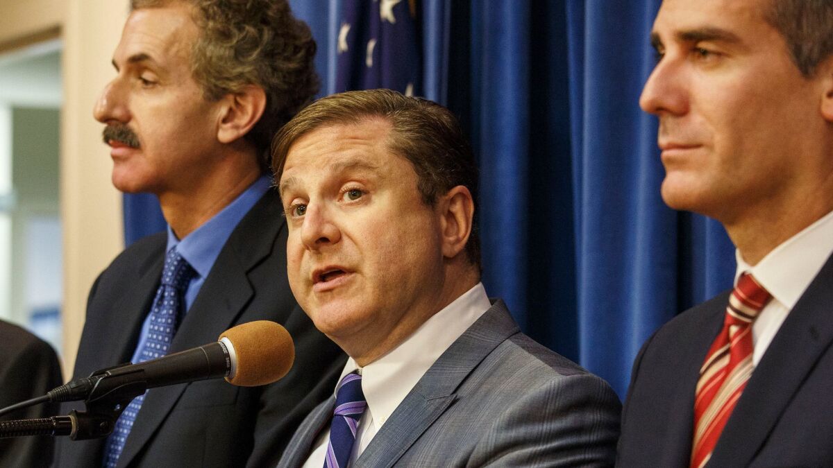 Los Angeles City Controller Ron Galperin is flanked by City Atty. Mike Feuer, left, and Mayor Eric Garcetti in 2015.