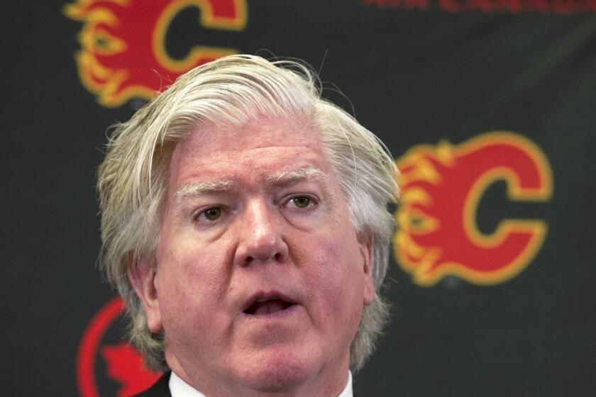 Brian Burke, who arrived on Sept. 5 as the Calgary Flames' president of hockey operations, will take over as acting general manager after dismissing Brian Feaster.