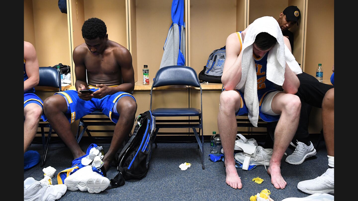 UCLA's Aaron Holiday and TJ Leaf, right, sit in the locker room after being eliminated by Kentucky during the Sweet 16 round of the NCAA tournament on March 24.