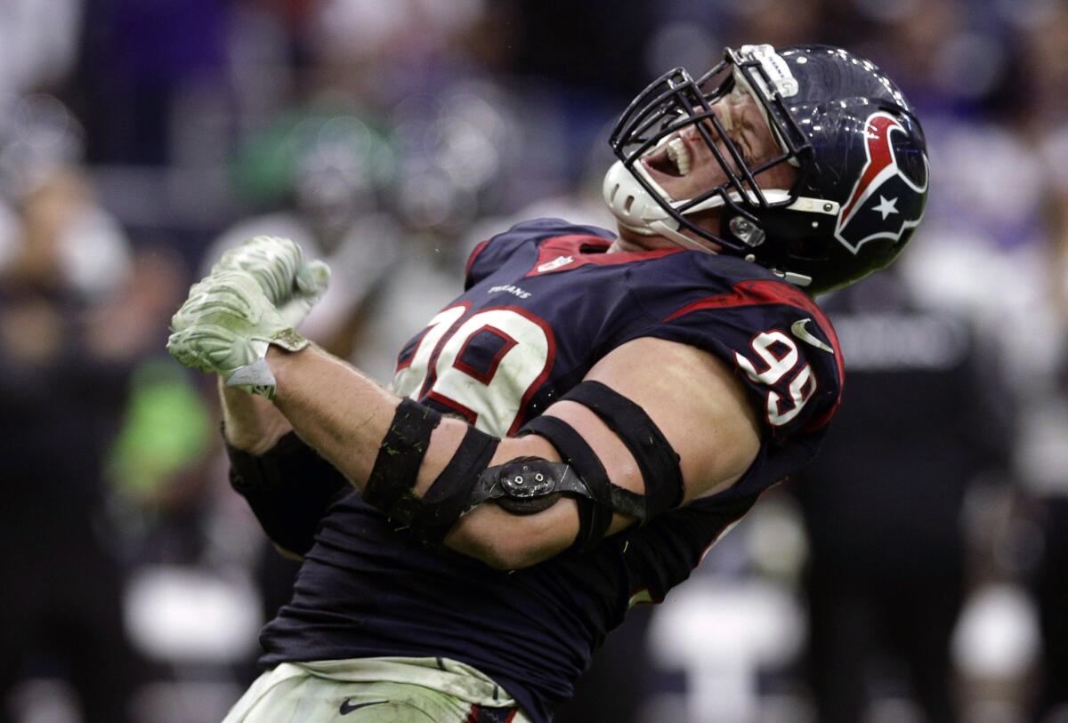 Houston defensive end J.J. Watt celebrates after sacking Baltimore quarterback Joe Flacco on Dec. 21, 2014.