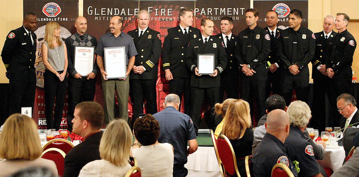 The Glendale engine 24 crew, right receives a unit citation during the Fire Department Awards Luncheon on Tuesday, October 2, 2013 along with Jeff St. Pierre, third from left and Dr. Shaun Torbati, fourth from left, receiving Fire Chief's Commendations for saving Amber Waller, second from left.