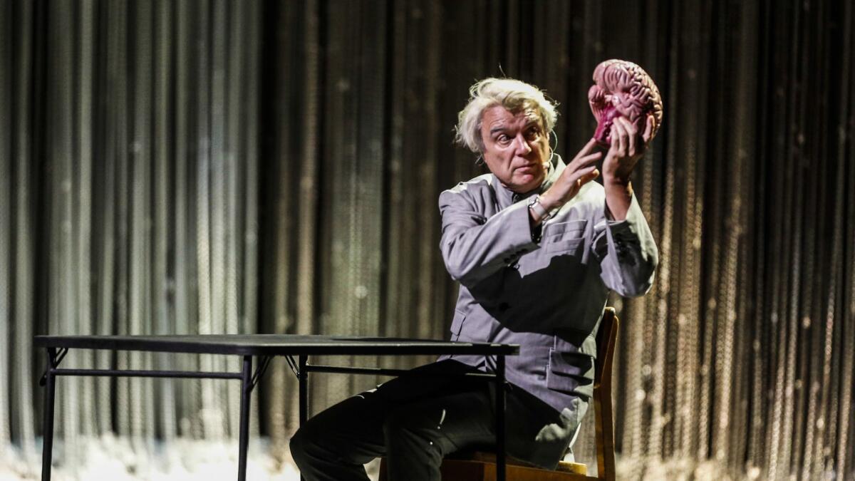 David Byrne employed a model of a human brain to illustrate his song "Here" in concert at the Shrine Auditorium in Los Angeles on Saturday.