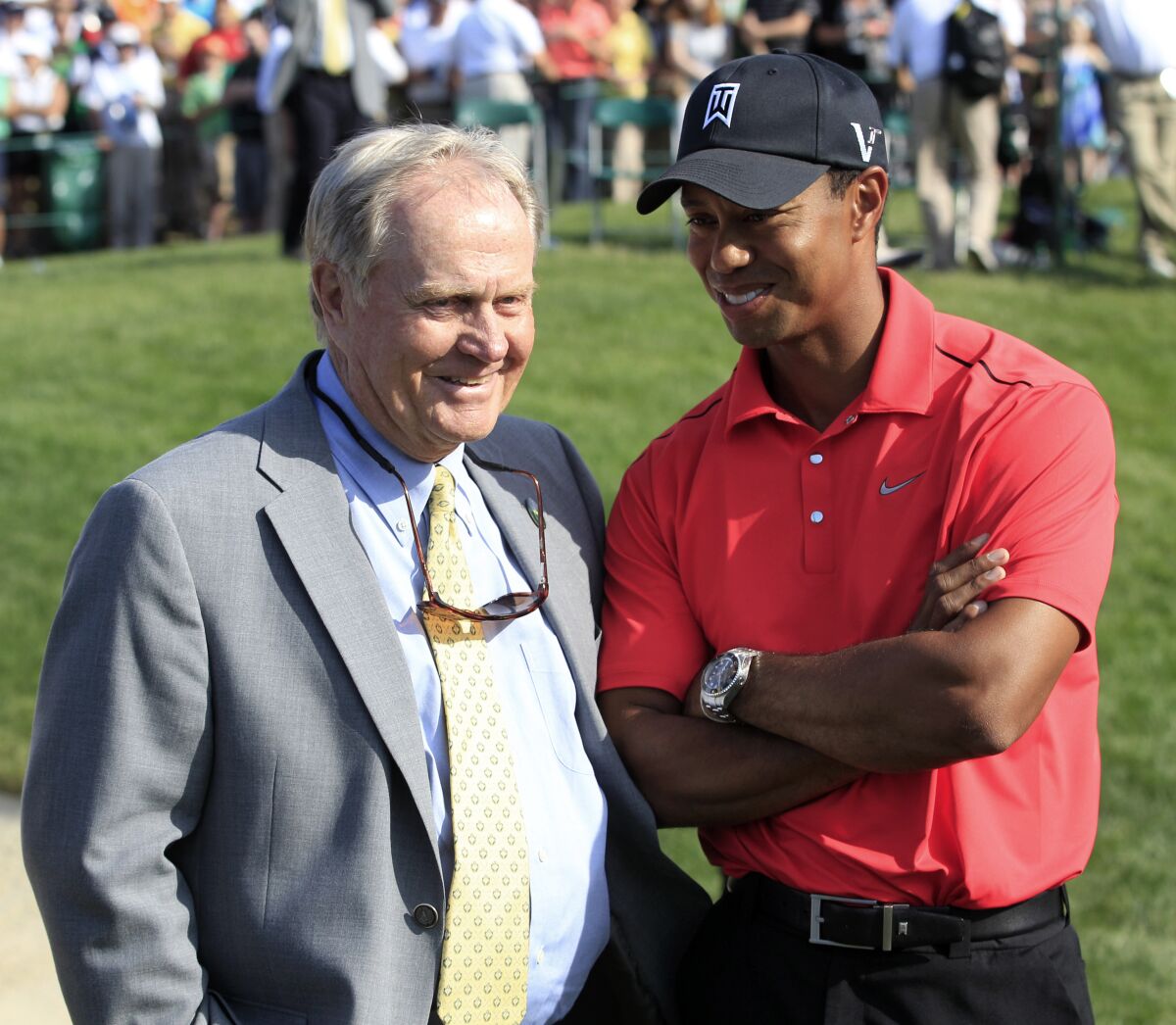 FILE - In this June 3, 2012, file photo, Jack Nicklaus, left, talks with Tiger Woods after Woods won the Memorial golf tournament at the Muirfield Village Golf Club in Dublin, Ohio. The PGA Tour has a deal that would bring a one-time event to Muirfield Village a week before the Memorial, giving it tournaments in consecutive weeks. (AP Photo/Tony Dejak, File)