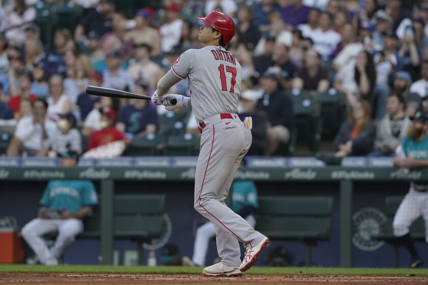 Los Angeles Angels' Shohei Ohtani watches his a solo home run during the third inning of the team's baseball game against the Seattle Mariners, Friday, July 9, 2021, in Seattle. (AP Photo/Ted S. Warren)
