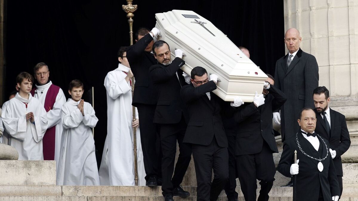 French rockerJohnny Hallyday was buried in a white coffin, just like star whose music he revered, Elvis Presley.