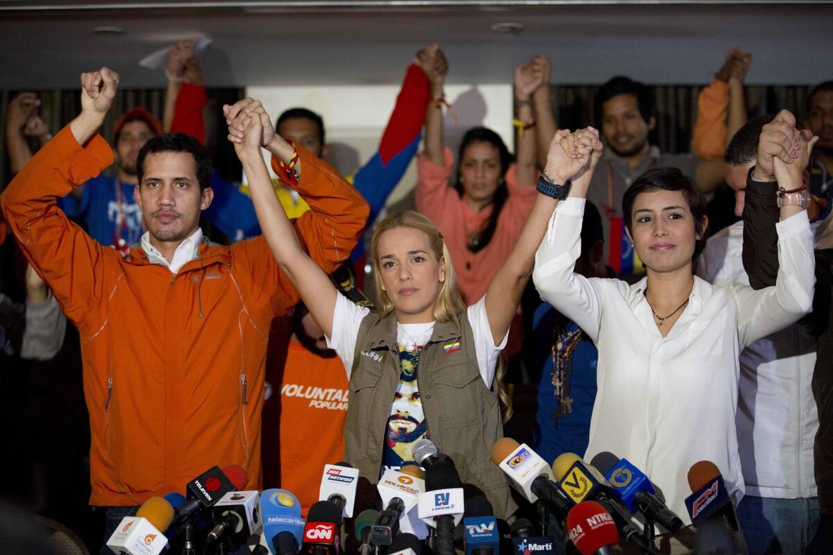 Lilian Tintori, center, wife of jailed opposition leader Leopoldo Lopez, is flanked by Patricia Ceballos, wife of jailed San Cristobal Mayor Daniel Ceballos, and an opposition member who was on hunger strike, at a news conference in Caracas, Venezuela.