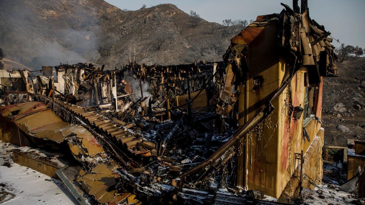 Heat and smoke rise from the rubble of a home that was destroyed by the Thomas fire in Montecito, Calif.
