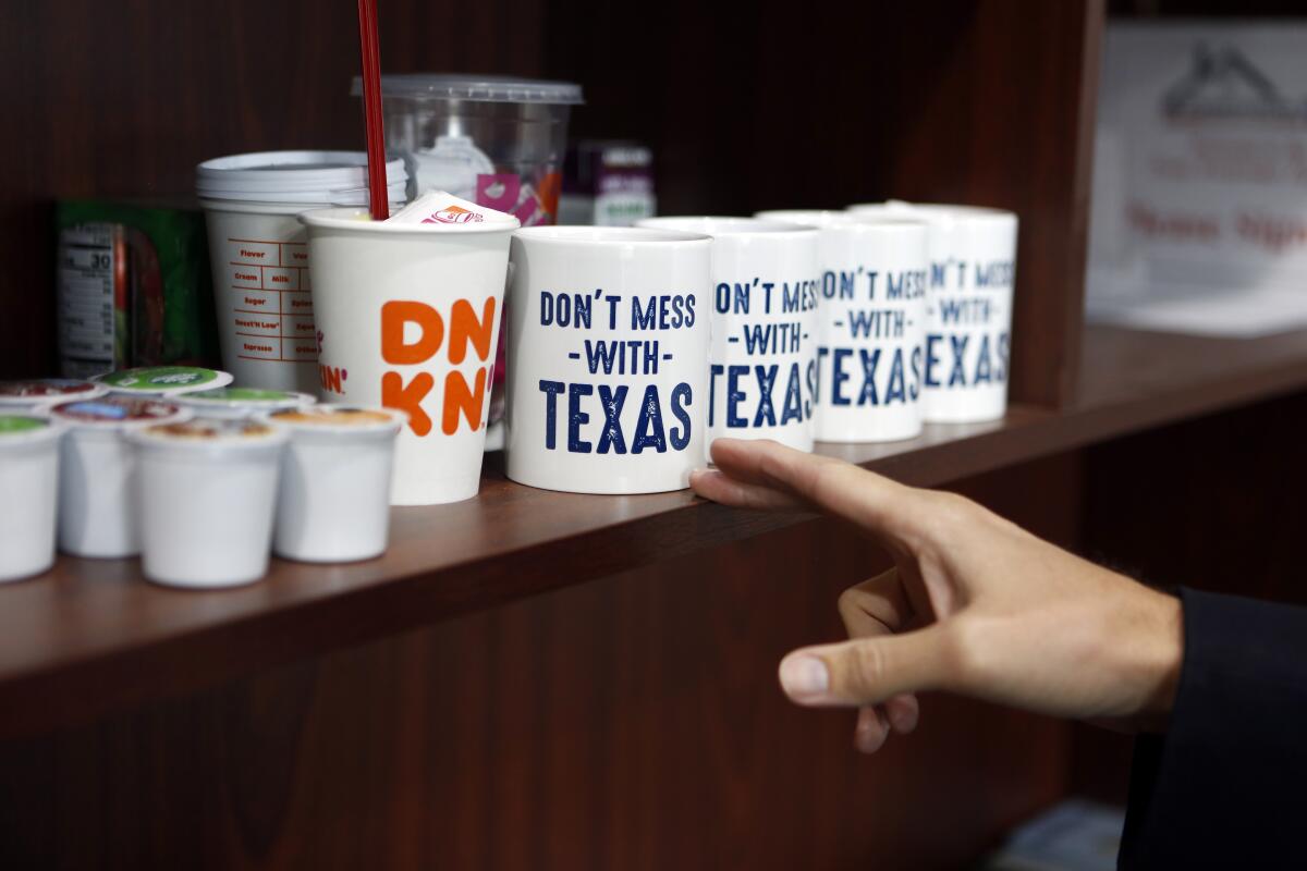 Conservative Move agent Derek Baker keeps "Don't Mess With Texas" mugs to give to clients in his office in McKinney, Texas. Baker helps conservatives find homes in the area.