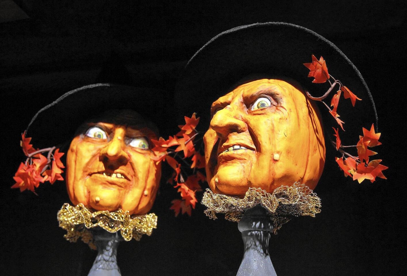 Two creepy scarecrow pumpkins by artist Sylver on display at the Roger's Gardens annual Halloween boutique.