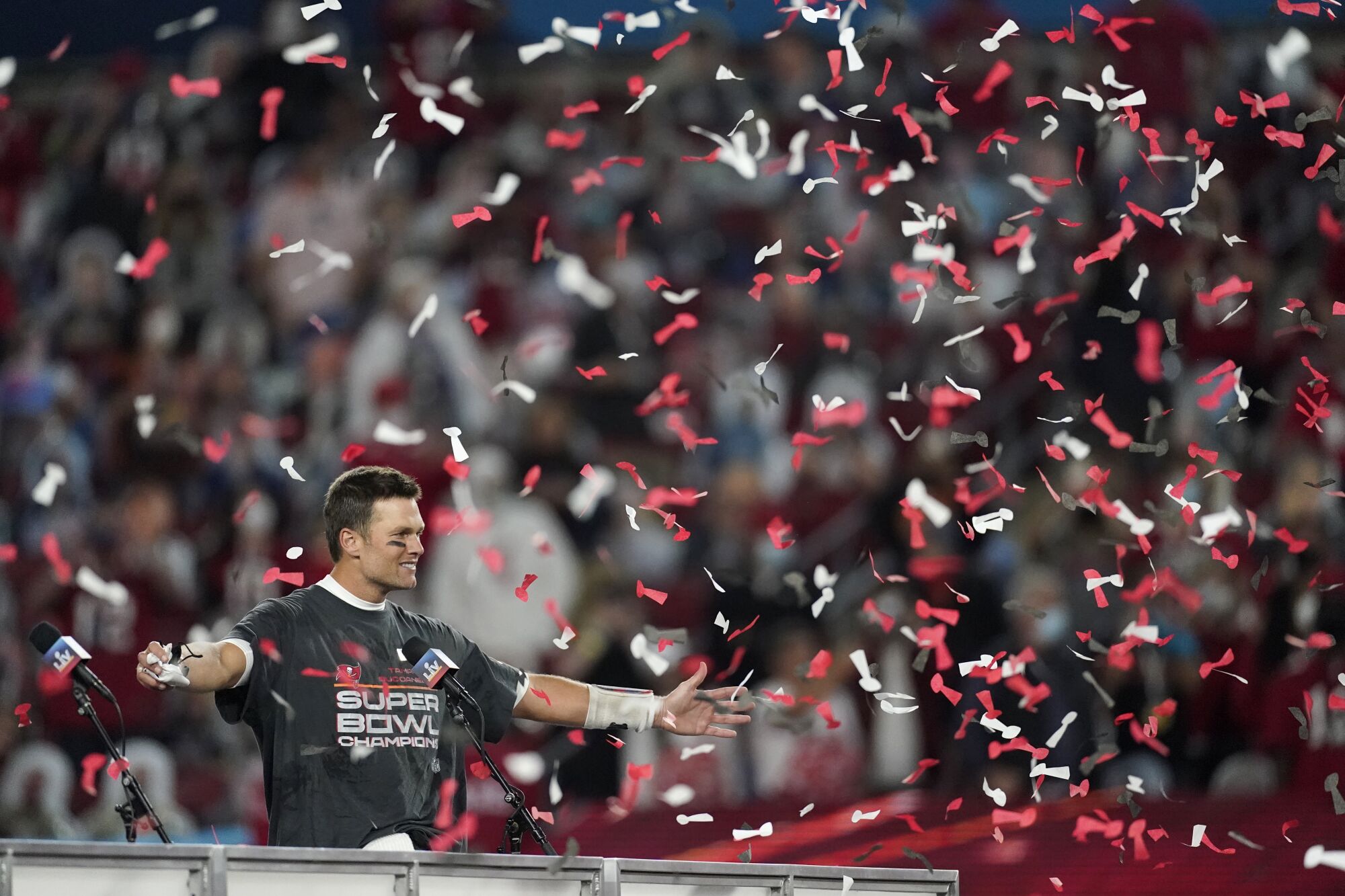 Tampa Bay quarterback Tom Brady celebrates as confetti falls following Super Bowl LV. 