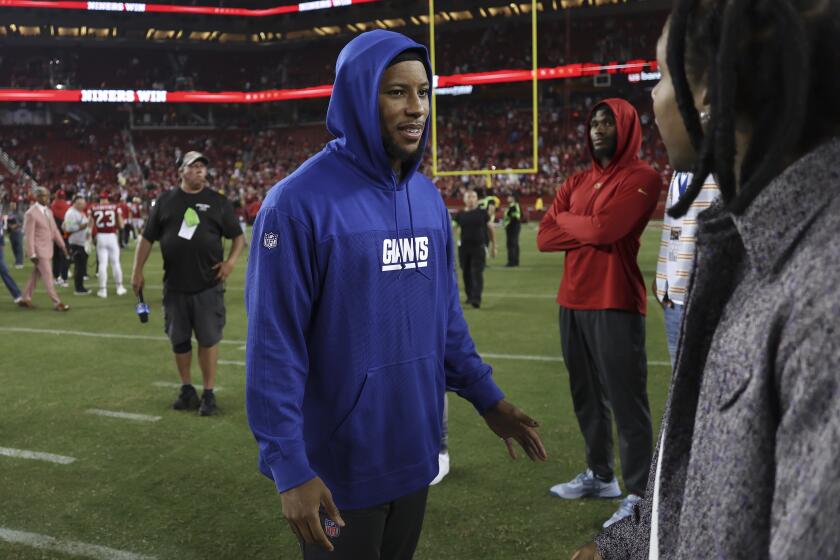 Injured New York Giants running back Saquon Barkley stands on the field after an NFL football game against the San Francisco 49ers in Santa Clara, Calif., Thursday, Sept. 21, 2023. (AP Photo/Jed Jacobsohn)