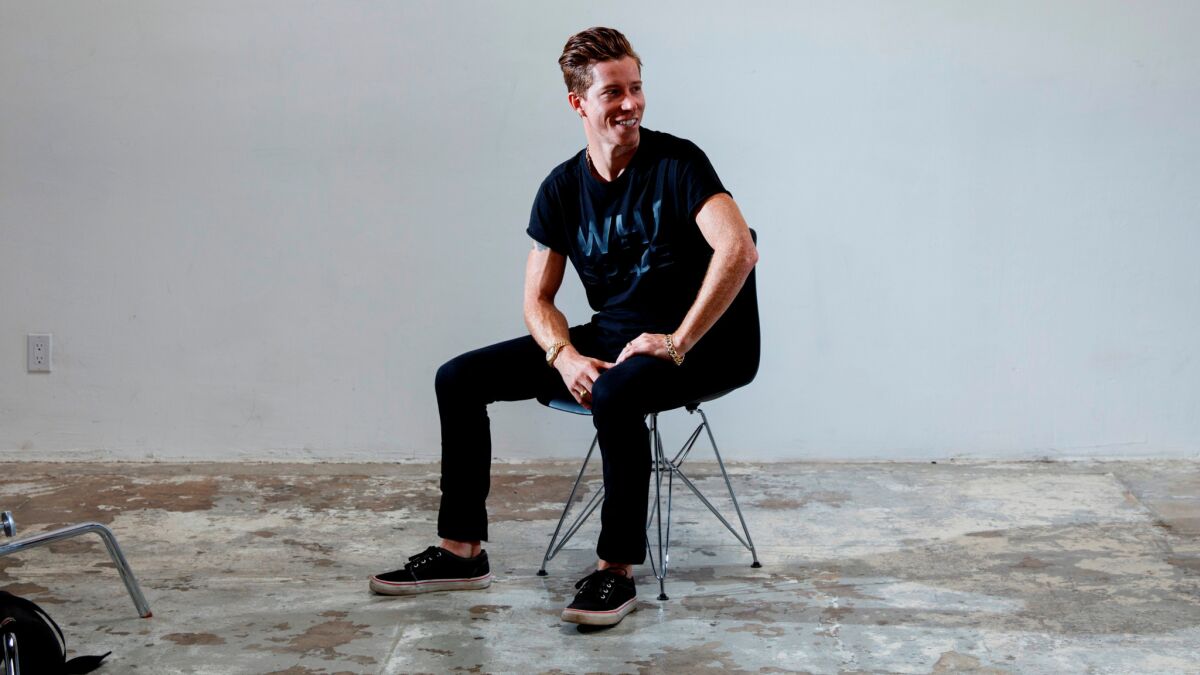 Two-time Olympic gold medal winner Shaun White wears a black WHT Space T-shirt, black slim-fit AllSaints jeans and black lace-up Vans at his downtown Los Angeles atelier.