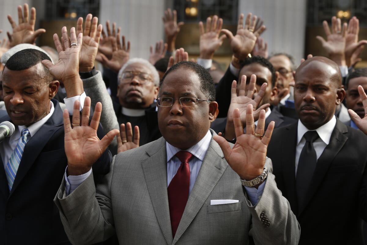 Los Angeles County Supervisor Mark Ridley-Thomas raises his hands during a silent vigil on the steps of the U.S. Federal Courthouse in downtown Los Angeles.