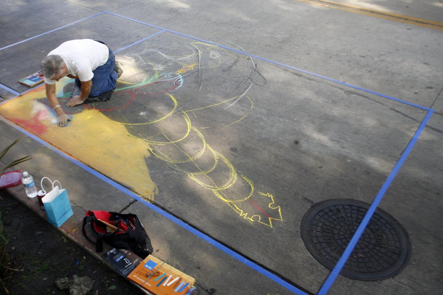 Oscar de Leon uses chalk to draw his 10' x 10' piece during Downtown Burbank ARTS Festival, which took place on San Fernando Rd. between Magnolia Blvd. and Olive Ave. on Saturday, November 3, 2012.
