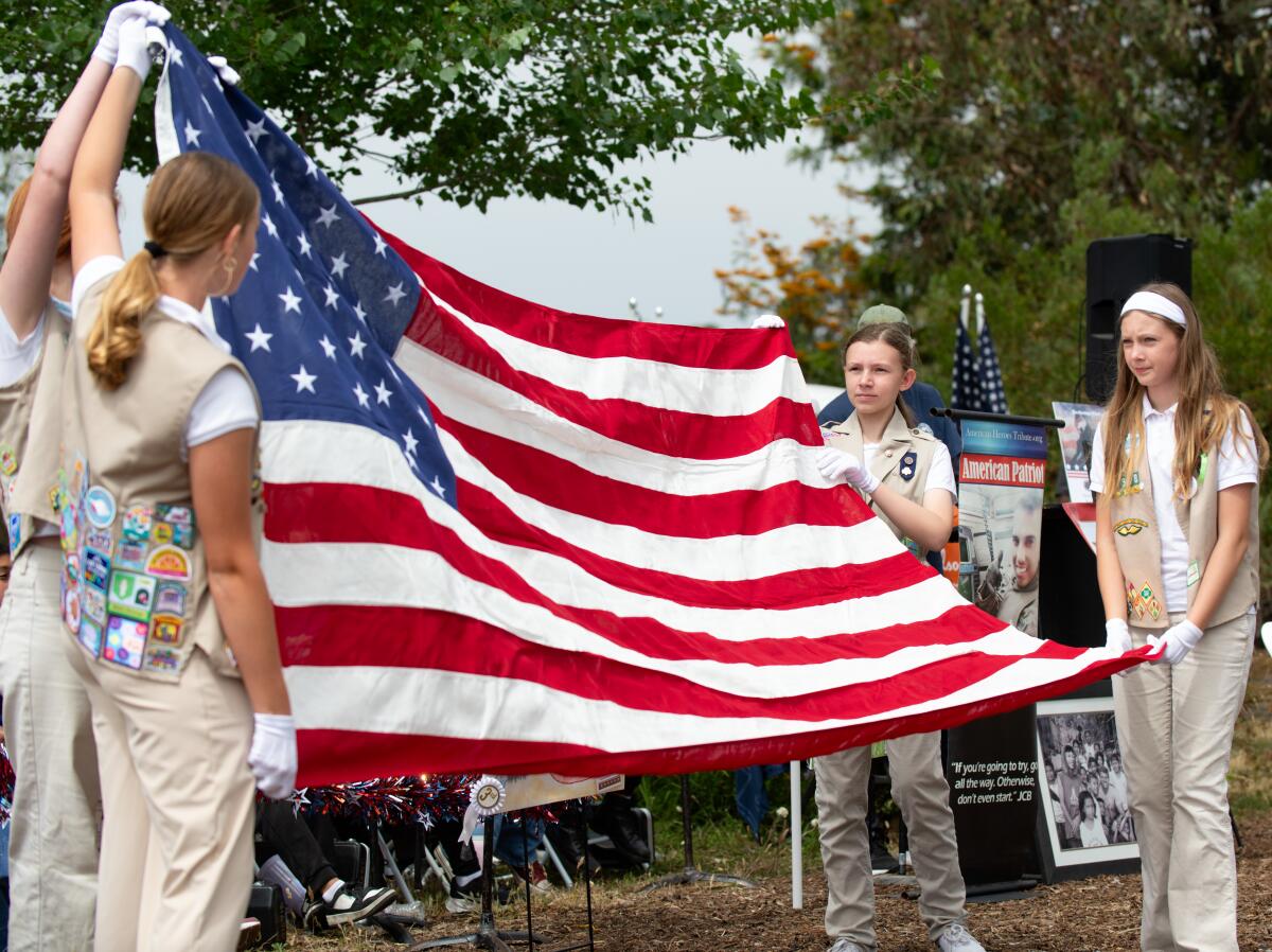Girl Scouts demonstrate how to properly fold Old Glory during the Field of Honor gathering.