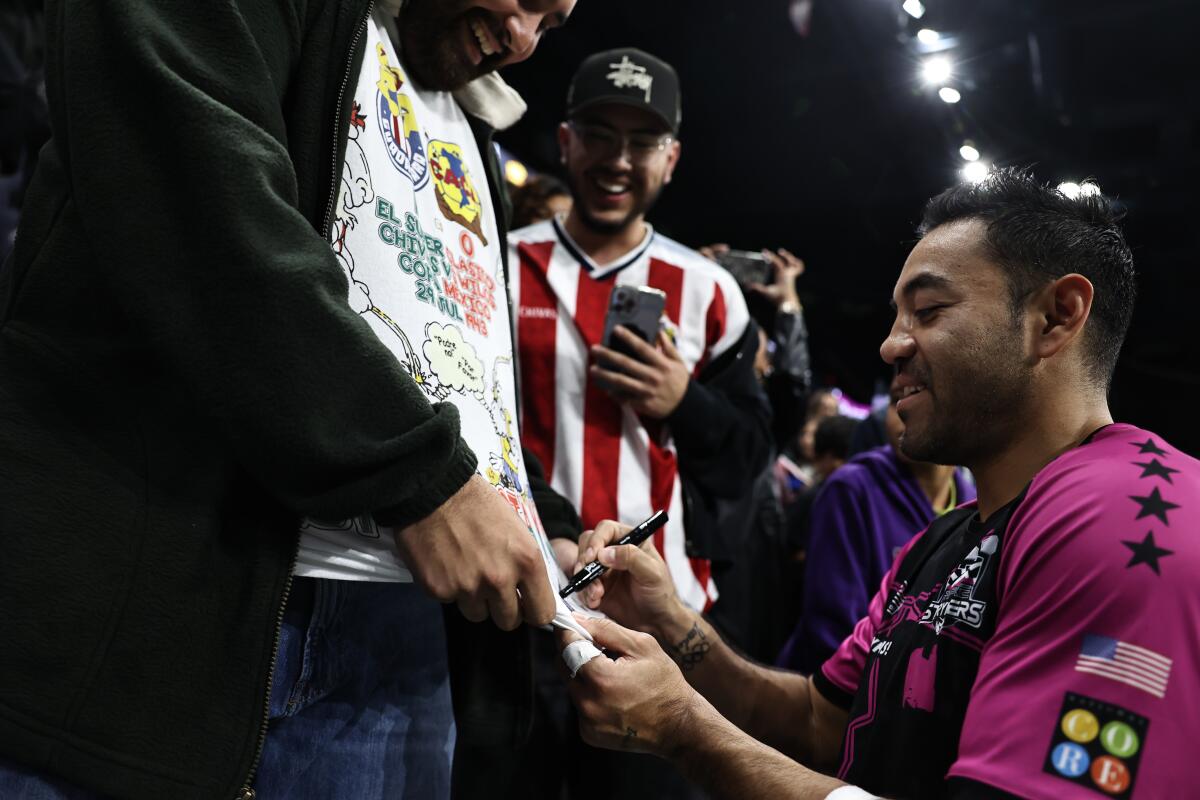 Empire Strykers midfielder Marco Fabian signs autographs during a game in December.