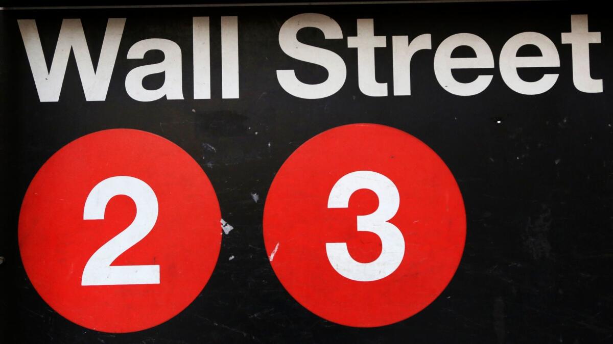Slightly more stocks on the New York Stock Exchange fell than rose. Above, a sign for a Wall Street subway station in New York.