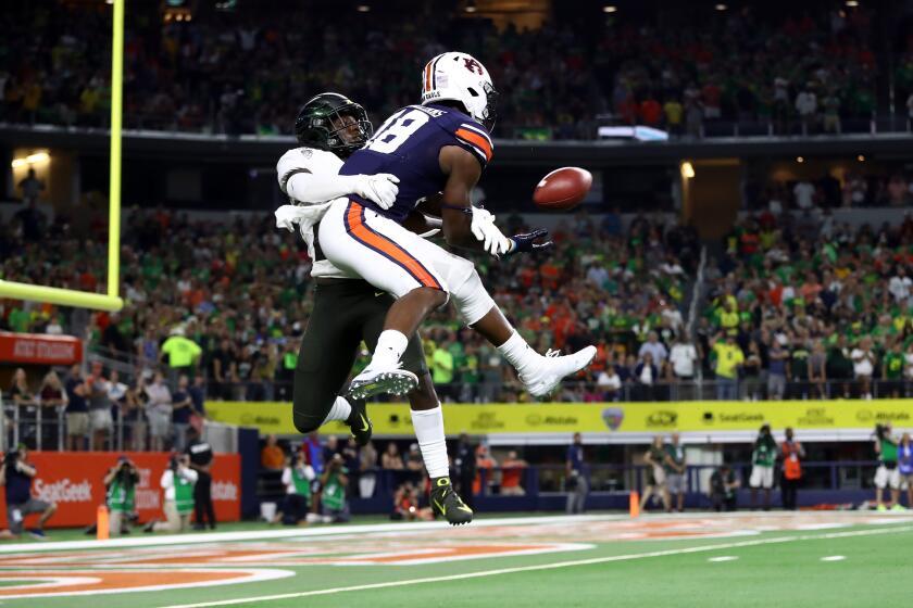 ARLINGTON, TEXAS - AUGUST 31: Seth Williams #18 of the Auburn Tigers makes the game winning touchdown pass against Verone McKinley III #23 of the Oregon Ducks in the fourth quarter during the Advocare Classic at AT&T Stadium on August 31, 2019 in Arlington, Texas. (Photo by Ronald Martinez/Getty Images)