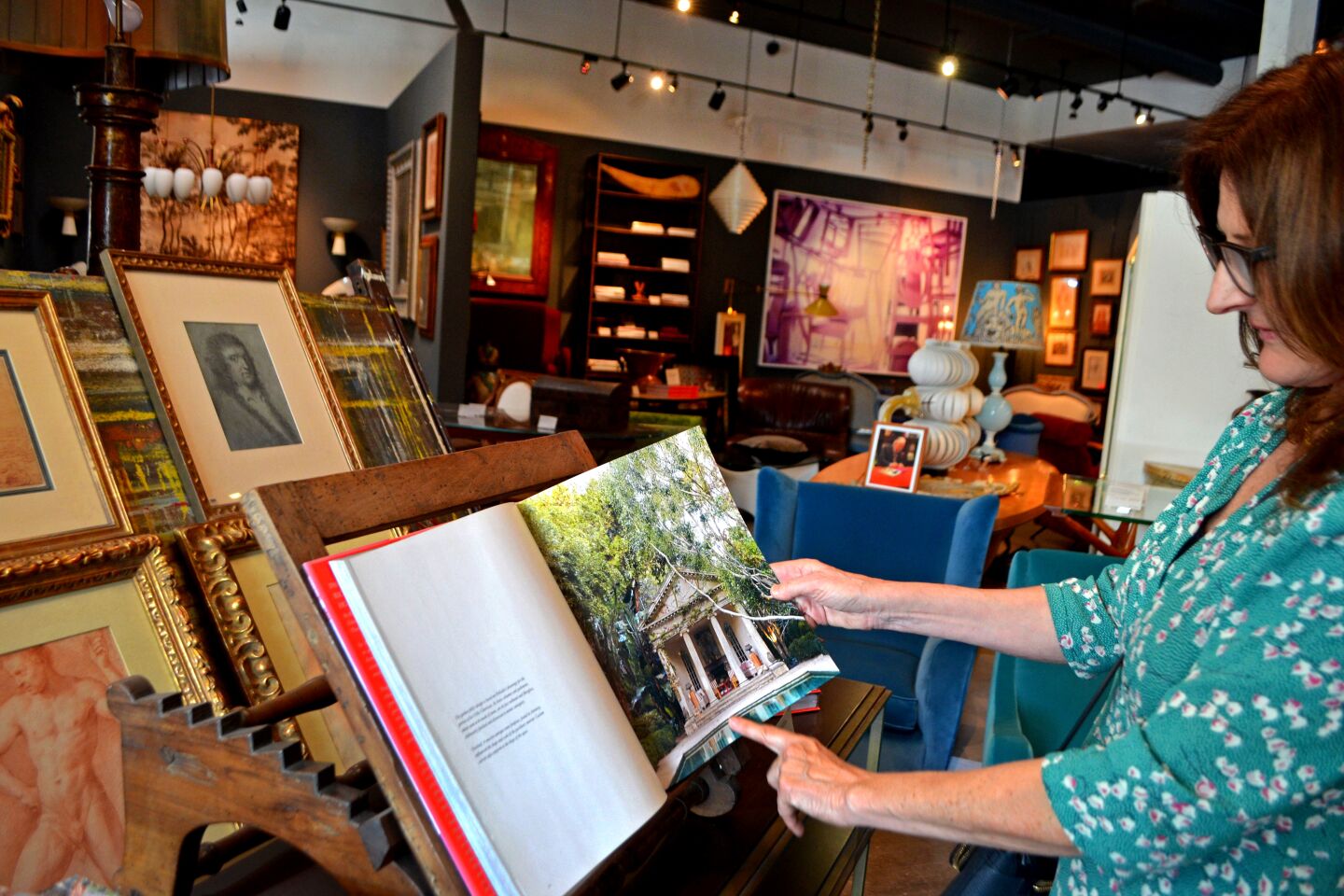 Kathryn Ireland at Richard Shapiro's La Cienega store perusing his book, "Past Perfect."