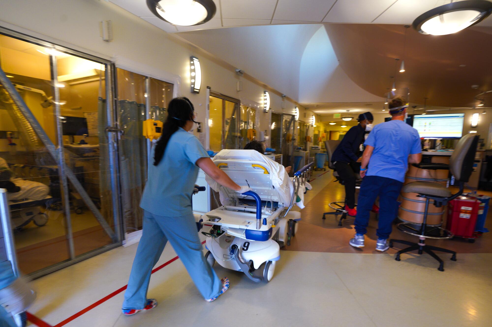 A patient is taken from the ambulance to an ER exam room at Sharp Grossmont Hospital.
