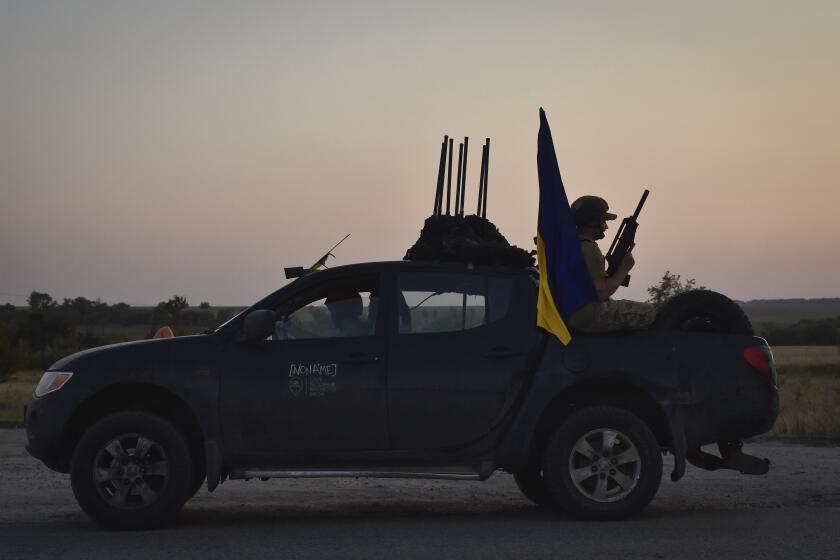 A soldier of Ukraine's 141st separate infantry brigade rides in a pickup truck at the frontline in Zaporizhzhia region, Ukraine, Monday, Aug. 19, 2024. (AP Photo/Andriy Andriyenko)