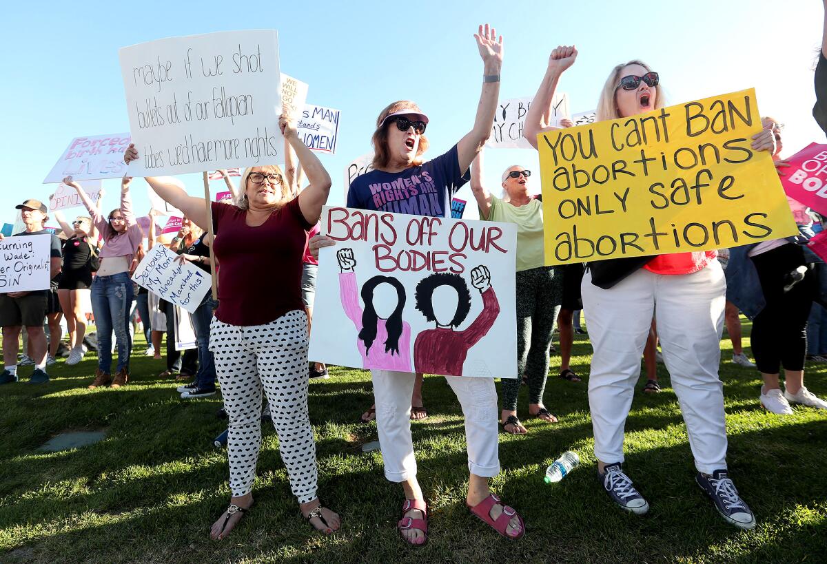 Julie Bauer, center, joins demonstrators as she protests the Supreme Court decision to overturn the Roe vs. Wade ruling.
