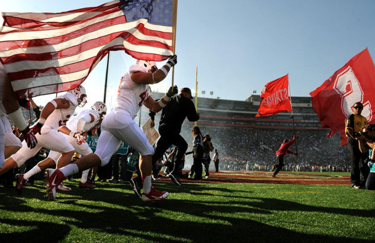 Stanford players run onto the field with the American flag before the start of Wednesday's Rose Bowl game with Michigan State. The venue may be the same, but the field will be brand new for Monday's BCS championship game between Florida State and Auburn.